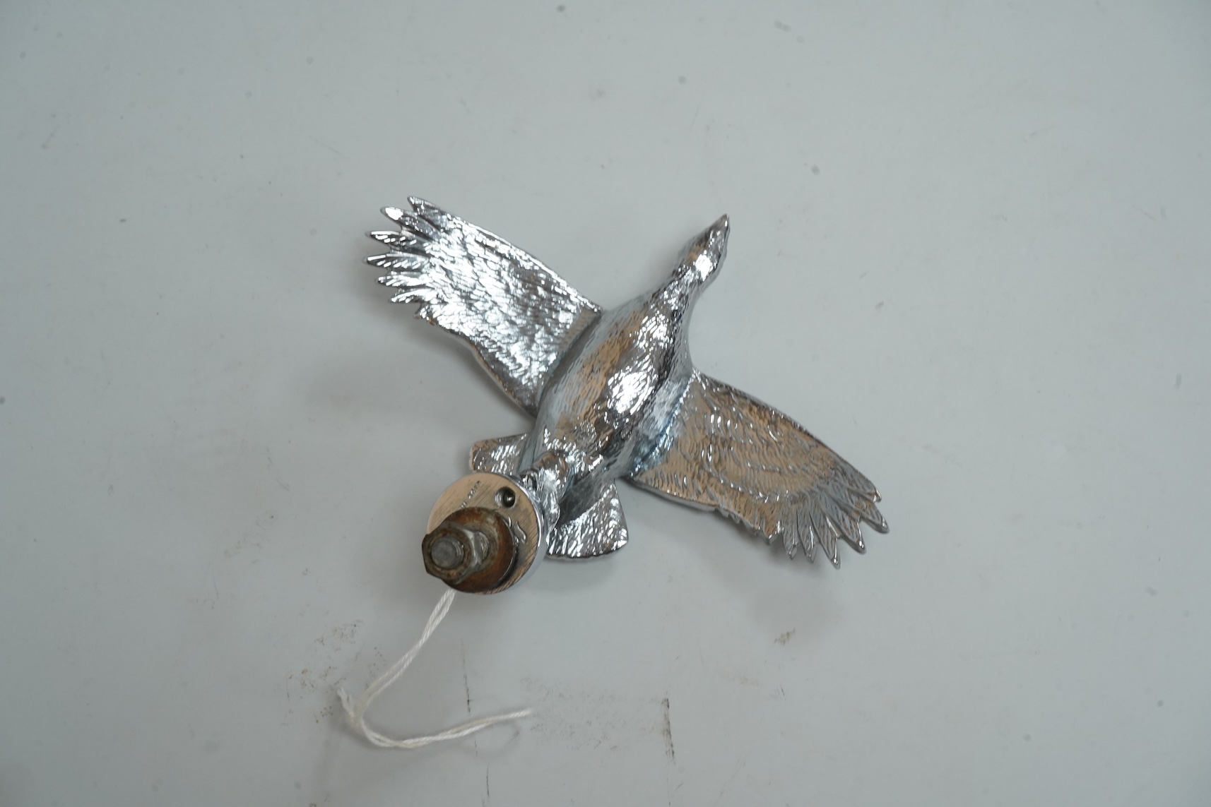 A Louis Lejeune cast chrome plated car mascot modelled as a bird in flight, wing span 12cm